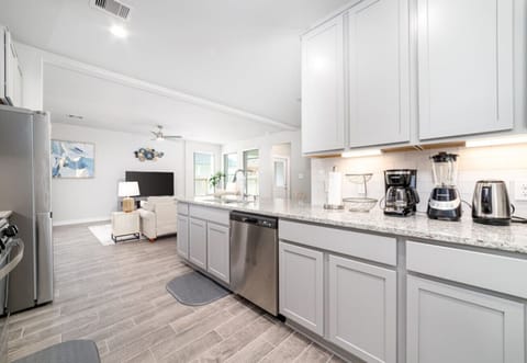 Spacious kitchen with ample counter space and modern appliances, perfect for cooking and entertaining.