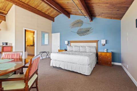 Room 12 is located on the third floor of the Inlet Building. It has a king-size bed and in-room dining table.