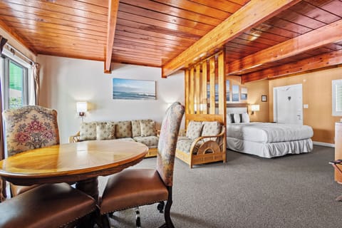Room 6 is located on the second floor of the Inlet Building. It has a king-size bed, sofa, dining table and a sliding door overlooking the inlet park.