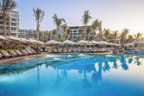 Large swimming infinity pool, with view to The Arch, with comfortable furniture.