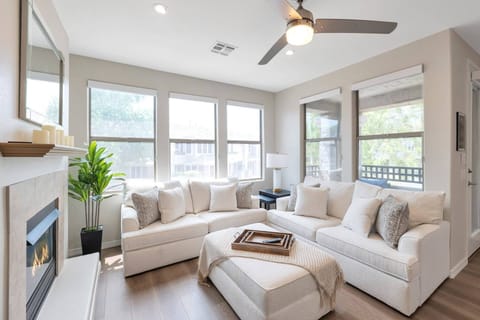 Living room with sofa, love seat, gas heater & 46" TV with Cable