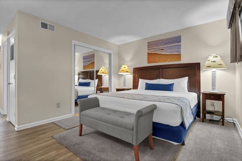 Sink into your cozy king bed with crisp linens and nautical touches. The elegant bench and warm lighting create perfect ambiance for relaxation.