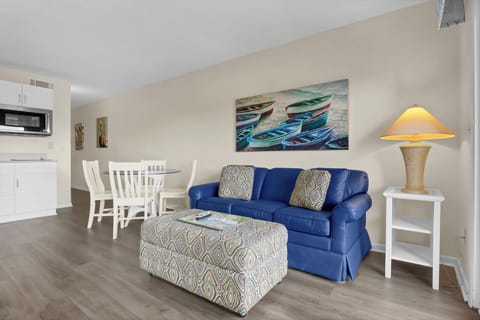 Sink into your comfortable blue sofa and admire the nautical artwork while enjoying the open-concept living space with kitchenette and dining area.