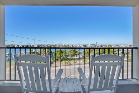 Unwind on your private balcony with comfortable seating and sweeping views of the coastal community below.