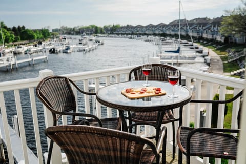 A small charcuterie board and two wine glasses set on the bistro table on a sunny afternoon 
