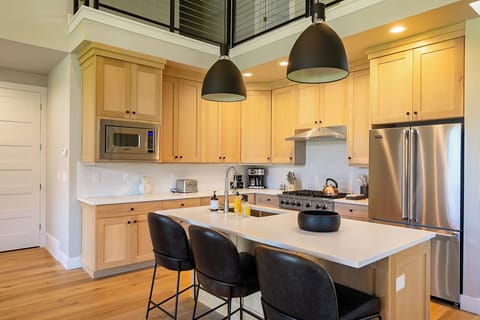 The sleek and stylish kitchen is a chef’s delight, complete with Viking appliances, elegant cabinetry, and ample cooking space.