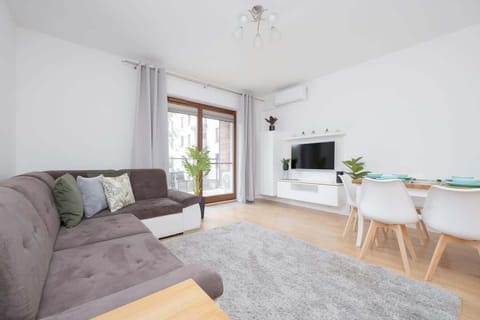 Relax in the stylish living room with a comfortable sofa and modern decor.