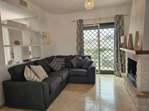 Villa | Living area | TV, fireplace