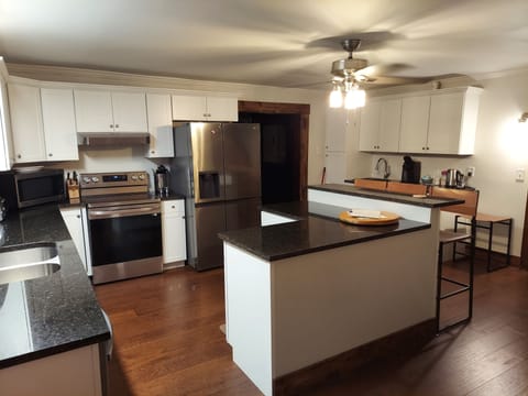 The newly renovated kitchen is spacious for your family to cook together.