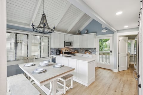 The villa features an open floor plan, seamlessly connecting the living room, dining area, and kitchen so no one is left behind while doing the chef's chores.