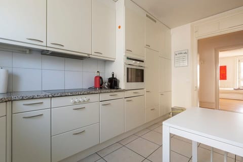 Bright and spacious kitchen with a big window and ample storage space -  fully equipped with dishwasher, fridge, microwave, oven, toaster, Nespresso coffee machine etc. 

A cozy table for casual dining or as additional tabletop space.