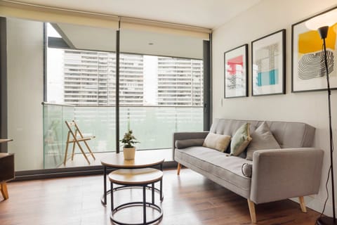Modern living area with city views and balcony access, perfect for relaxation.