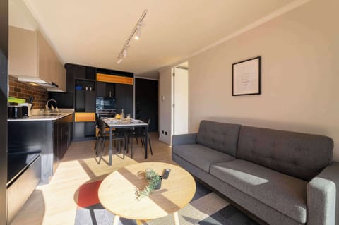 Cozy and modern living space with natural light, perfect for relaxing or dining in style.