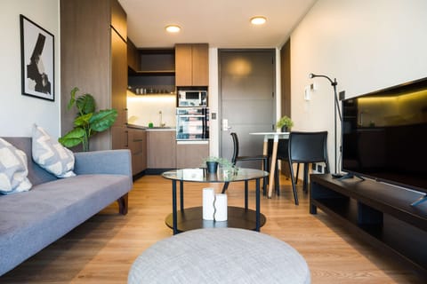 Cozy and modern living space with a sleek kitchen and dining area, perfect for relaxing or entertaining.