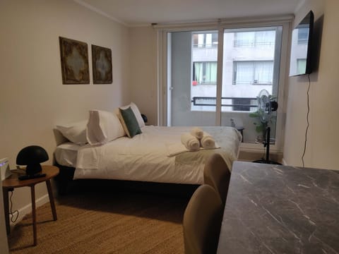 Cozy studio with modern amenities and a large window for natural light. Perfect for a relaxing stay in the city.