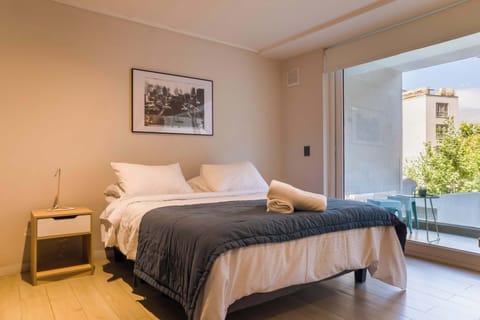 Unwind in this inviting bedroom with a private balcony and enjoy the lush green views.