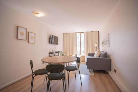 Bright and cozy living space with modern furnishings and ample natural light, perfect for relaxing or entertaining.