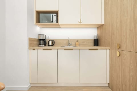 A beige and tasteful kitchenette that encourages culinary exploration.
