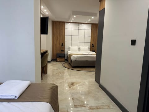 Deluxe Triple Room, City View | In-room safe, individually decorated, individually furnished, desk