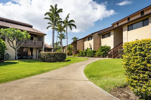 Property exterior with lush landscaping and palm trees