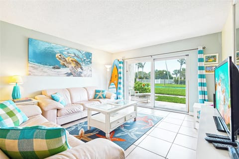 Spacious living room with vibrant decor and a relaxing coastal feel