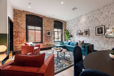 Relax in the living area with a smart TV, stylish seating, and a queen-sized sleeper sofa for extra guests. Perfect for families or group stays in New Orleans, this inviting space is ideal for movie nights or recharging after a day in the city.