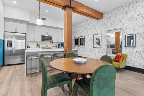 Enjoy meals together at your in-suite dining table with seating for your group. Whether it's takeout, delivery, or a home-cooked meal, this cozy dining area makes every stay at 888 Baronne feel like home in New Orleans.
