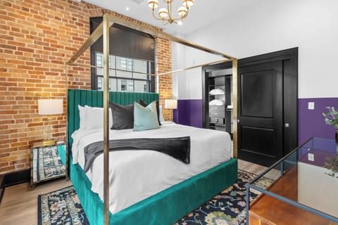 Retreat to the primary bedroom with a plush king bed, walk-in closet, blackout shades, and a smart TV. Designed for comfort and privacy, this suite is perfect for recharging after a day exploring New Orleans.