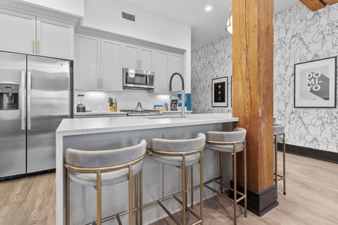 Cook or snack in style with a full kitchen featuring GE stainless appliances, cookware, and an island with bar seating. Ideal for short or extended stays, our kitchens make group travel in New Orleans easy and comfortable.