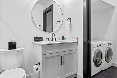 The studio bathroom includes fresh towels, a hairdryer, and complimentary toiletries. Conveniently located near the living area, it's stylish and practical—perfect for guests, families, or sharing during group stays at 888 Baronne.