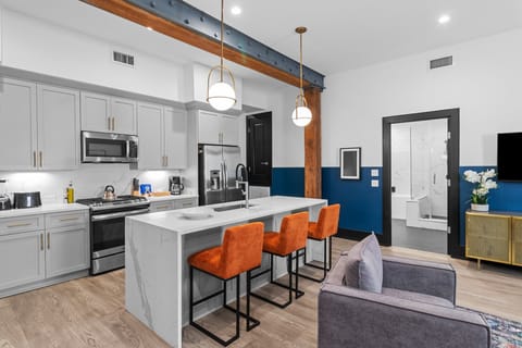 Cook or snack in style with a full kitchen featuring GE stainless appliances, cookware, and an island with bar seating. Ideal for short or extended stays, our kitchens make group travel in New Orleans easy and comfortable.