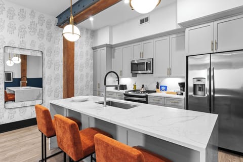 Cook or snack in style with a full kitchen featuring GE stainless appliances, cookware, and an island with bar seating. Ideal for short or extended stays, our kitchens make group travel in New Orleans easy and comfortable.