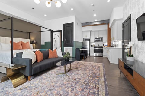 Relax in the living area with a smart TV, stylish seating, and a sleeper sofa for extra guests. Perfect for families or group stays in New Orleans, this inviting space is ideal for movie nights or recharging after a day in the city.