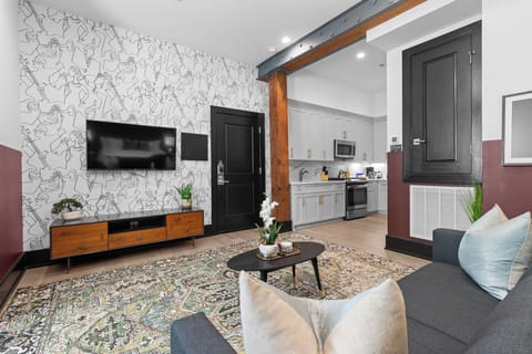 Relax in the living area with a smart TV, stylish seating, and a sleeper sofa for extra guests. Perfect for families or group stays in New Orleans, this inviting space is ideal for movie nights or recharging after a day in the city.