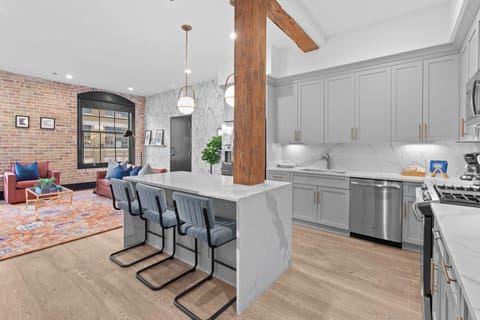 Cook or snack in style with a full kitchen featuring GE stainless appliances, cookware, and an island with bar seating. Ideal for short or extended stays, our kitchens make group travel in New Orleans easy and comfortable.