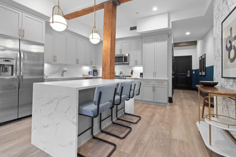 Cook or snack in style with a full kitchen featuring GE stainless appliances, cookware, and an island with bar seating. Ideal for short or extended stays, our kitchens make group travel in New Orleans easy and comfortable.