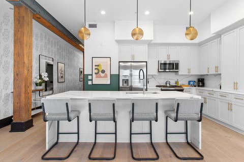 Cook or snack in style with a full kitchen featuring GE stainless appliances, cookware, and an island with bar seating. Ideal for short or extended stays, our kitchens make group travel in New Orleans easy and comfortable.