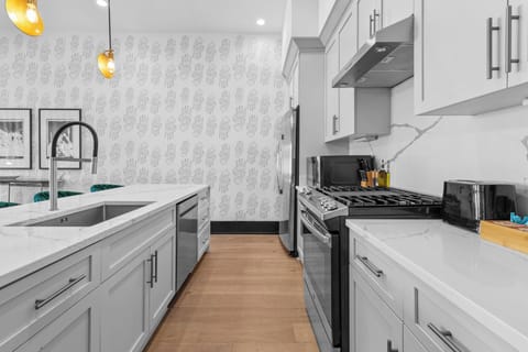 Cook or snack in style with a full kitchen featuring GE stainless appliances, cookware, and an island with bar seating. Ideal for short or extended stays, our kitchens make group travel in New Orleans easy and comfortable.