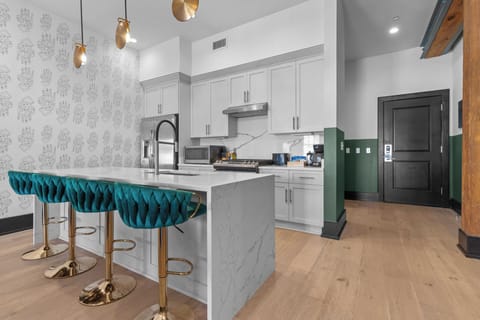 Cook or snack in style with a full kitchen featuring GE stainless appliances, cookware, and an island with bar seating. Ideal for short or extended stays, our kitchens make group travel in New Orleans easy and comfortable.