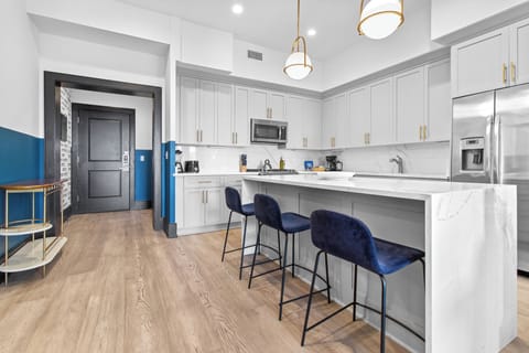 Cook or snack in style with a full kitchen featuring GE stainless appliances, cookware, and an island with bar seating. Ideal for short or extended stays, our kitchens make group travel in New Orleans easy and comfortable.
