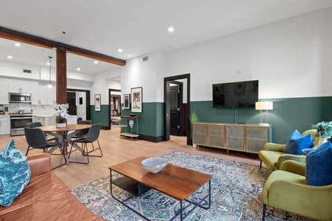 Relax in the living area with a smart TV, stylish seating, and a sleeper sofa for extra guests. Perfect for families or group stays in New Orleans, this inviting space is ideal for movie nights or recharging after a day in the city.