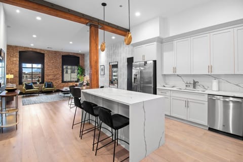 Cook or snack in style with a full kitchen featuring GE stainless appliances, cookware, and an island with bar seating. Ideal for short or extended stays, our kitchens make group travel in New Orleans easy and comfortable.