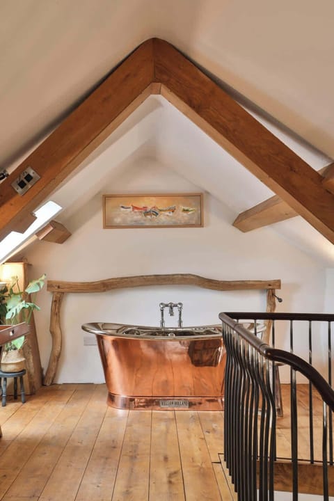 Luxurious bathroom with a stunning free-standing copper bath – the perfect spot to unwind in style.