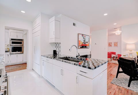 Stainless steel accents and sleek countertop elevate your cooking experience in this modern kitchen. ✨