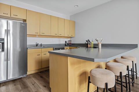 Mixing modern and rustic vibes in my kitchen with sleek stainless steel appliances and cozy wooden floors.