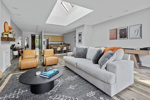 Basking in the natural glow of the skylight, cozied up on this comfy couch. Perfect spot for some quality 'me' time!