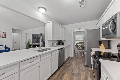 Fully equipped kitchen with stainless steel appliances.