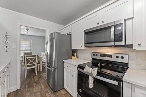 Fully equipped kitchen with stainless steel appliances.