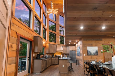 Fully equipped chef’s kitchen with granite countertops and bar seating.