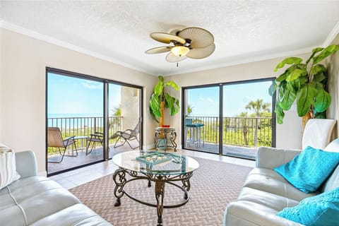 Cozy living room with stylish furnishings and breathtaking coastline views.